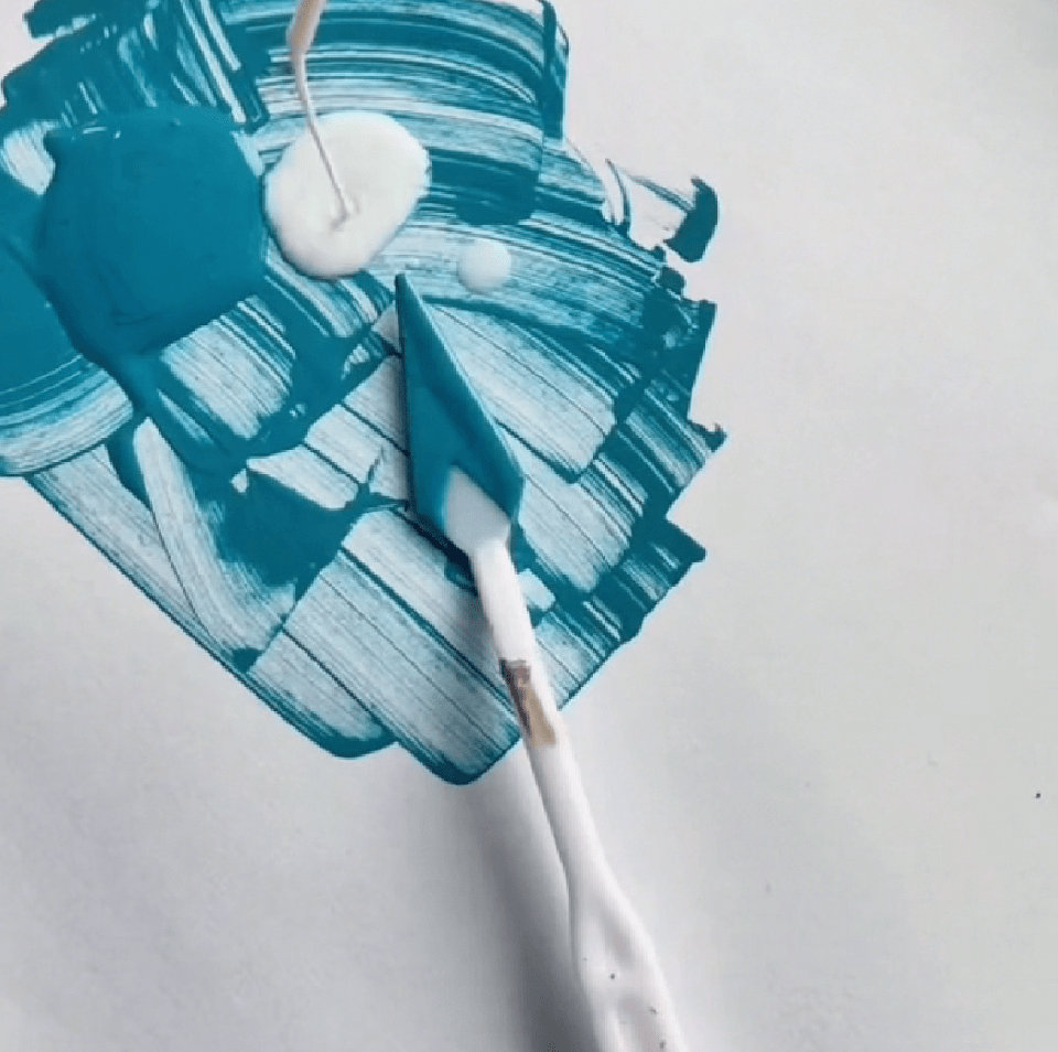 Mixing Angelus turquoise acrylic paint with 2-Soft Fabric Medium for flexible fabric application.