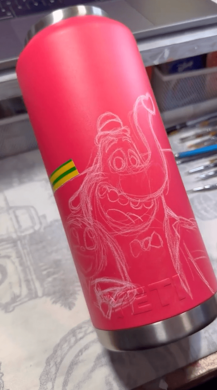 Sketching out Disney design on Tumbler before painting