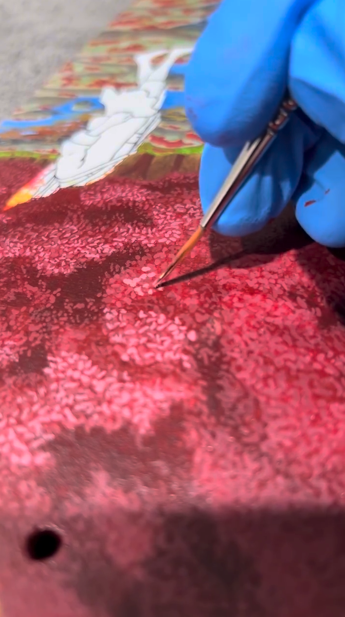 Painting red a and pink anime tree on a skateboard deck using Angelus Paints