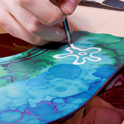 Custom guitar painted with vibrant, colorful designs using Angelus Paints.