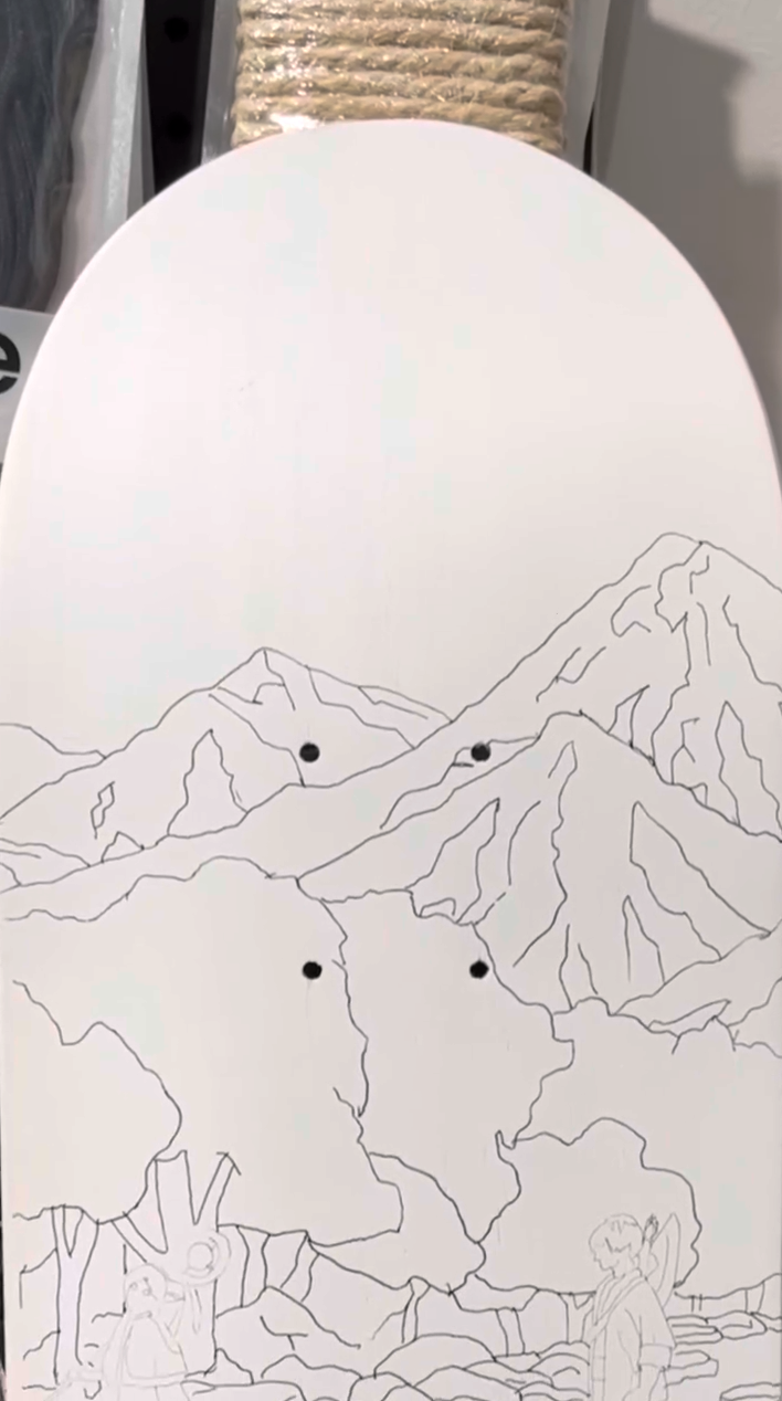Design sketched on skateboard with pencil prepping to paint