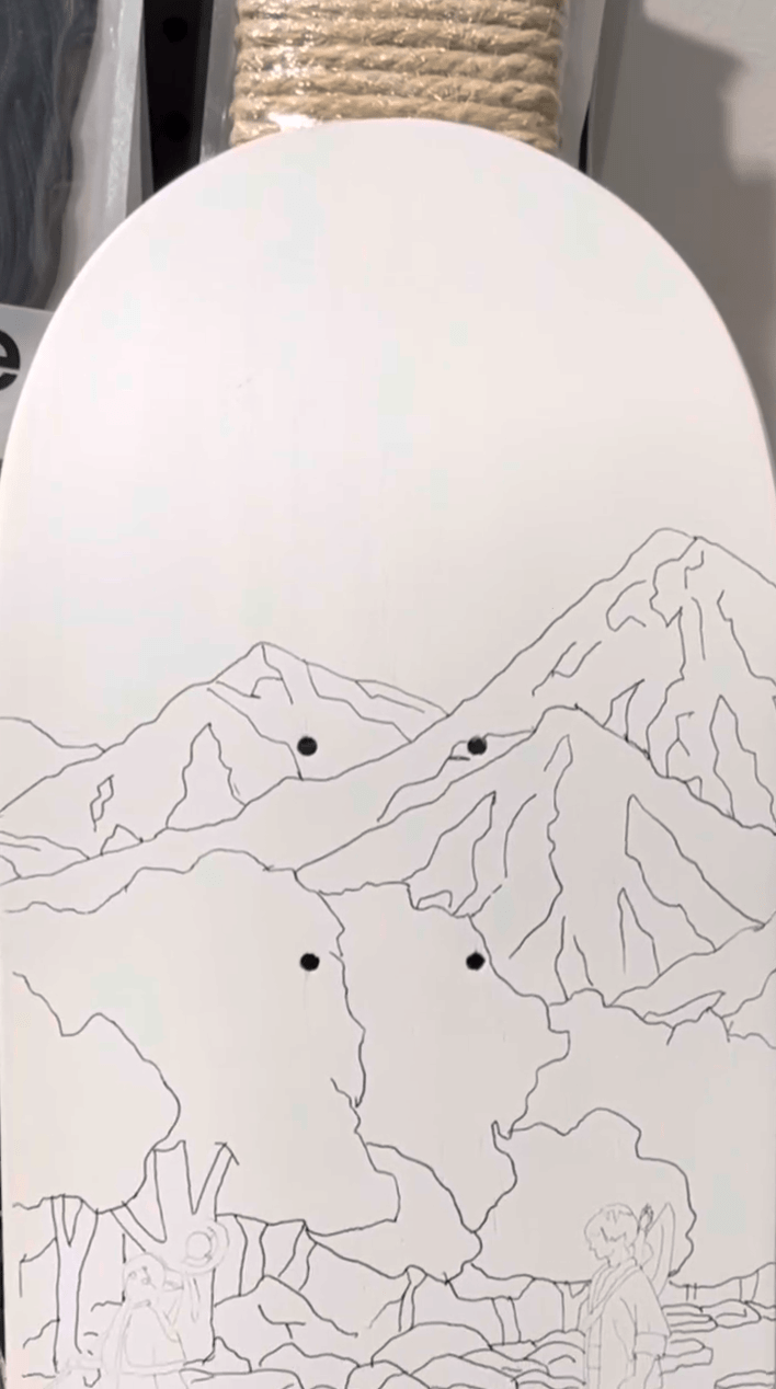 Design sketched on skateboard with pencil prepping to paint