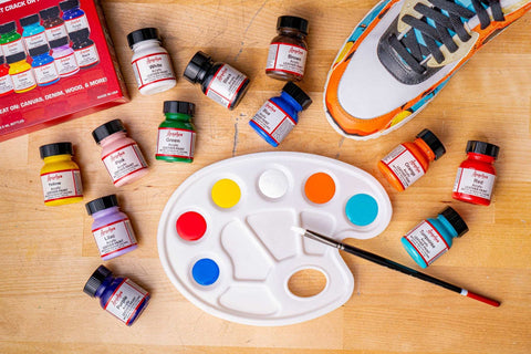 Angelus Leather Paint Kit beside a partially painted sneaker, showcasing vibrant paint application.