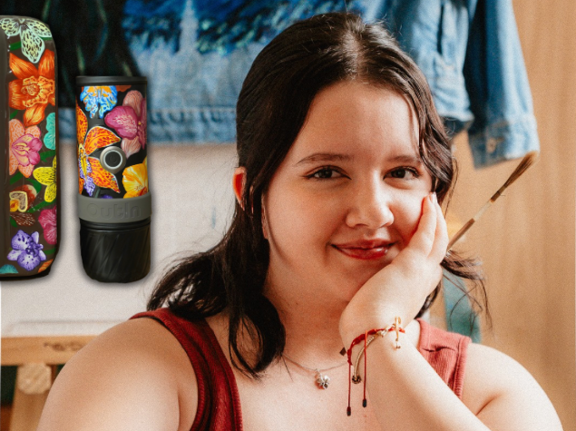 Overhead view of an artist applying custom hand-painted floral art to a mug using precision paintbrushes and Angelus acrylic paint.