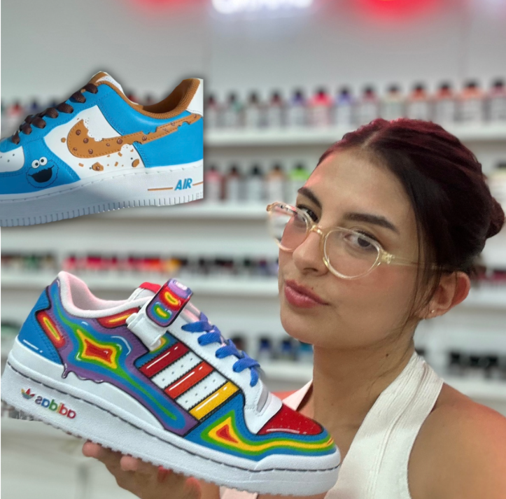 Custom hand-painted white Nike Air Force 1 sneakers featuring a blue Cookie Monster theme painted with Angelus Paint