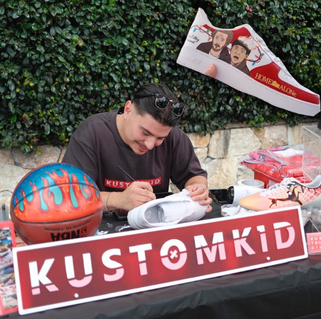 Custom hand-painted white Nike Air Force 1 sneakers featuring a Christmas Home Alone theme with Kevin McCallister and festive lights