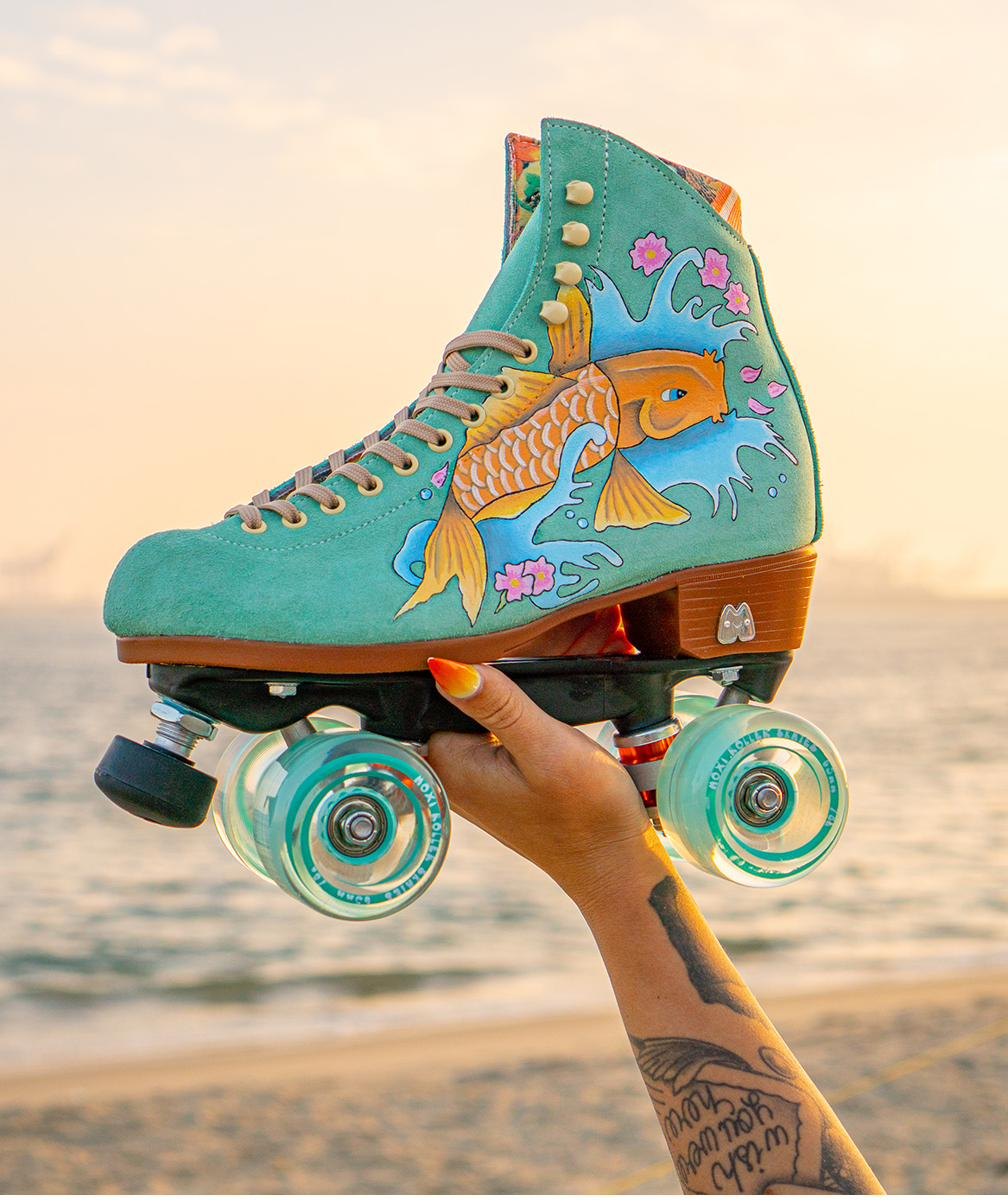 Teal suede roller skates custom painted with a koi fish design