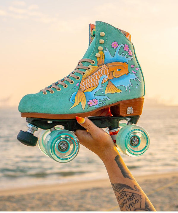 Teal suede roller skates custom painted with a koi fish design