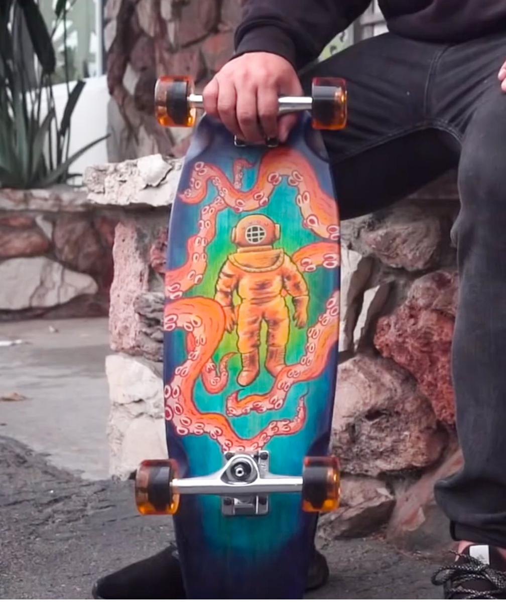 Hand painting a design on a skateboard deck with Angelus Paint