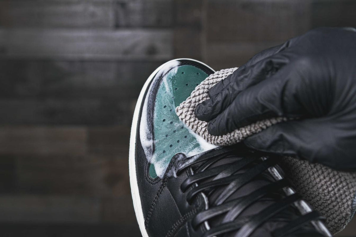Wiping a sneaker with an Angelus microfiber towel after wearing it
