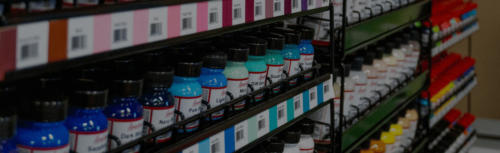Angelus airbrush paint—rows of acrylic leather paint bottles on store racks
