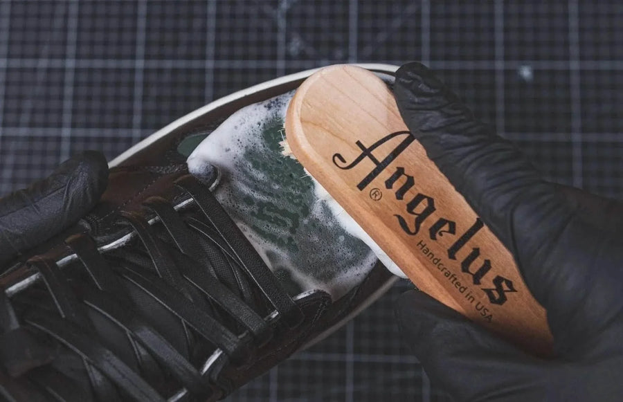 Angelus brush foaming cleaner onto a sneaker.