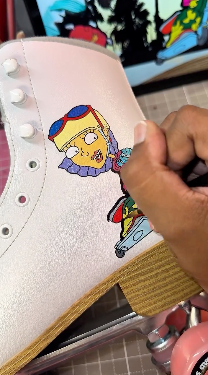 Applying vibrant Angelus Leather Paint to a custom cartoon skate design