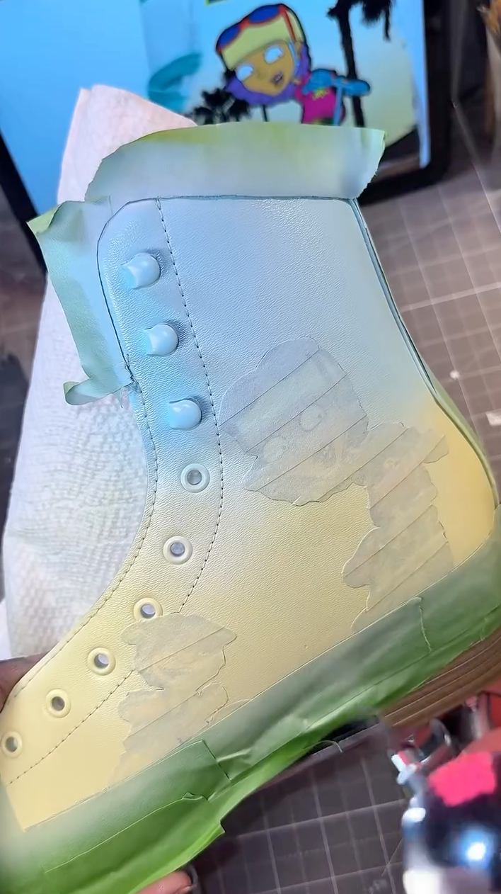 Using an airbrush to create a blue and yellow sunset gradient on skates