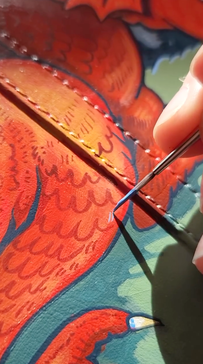 Painting tiny scale details on a dragon mural using Angelus leather paint