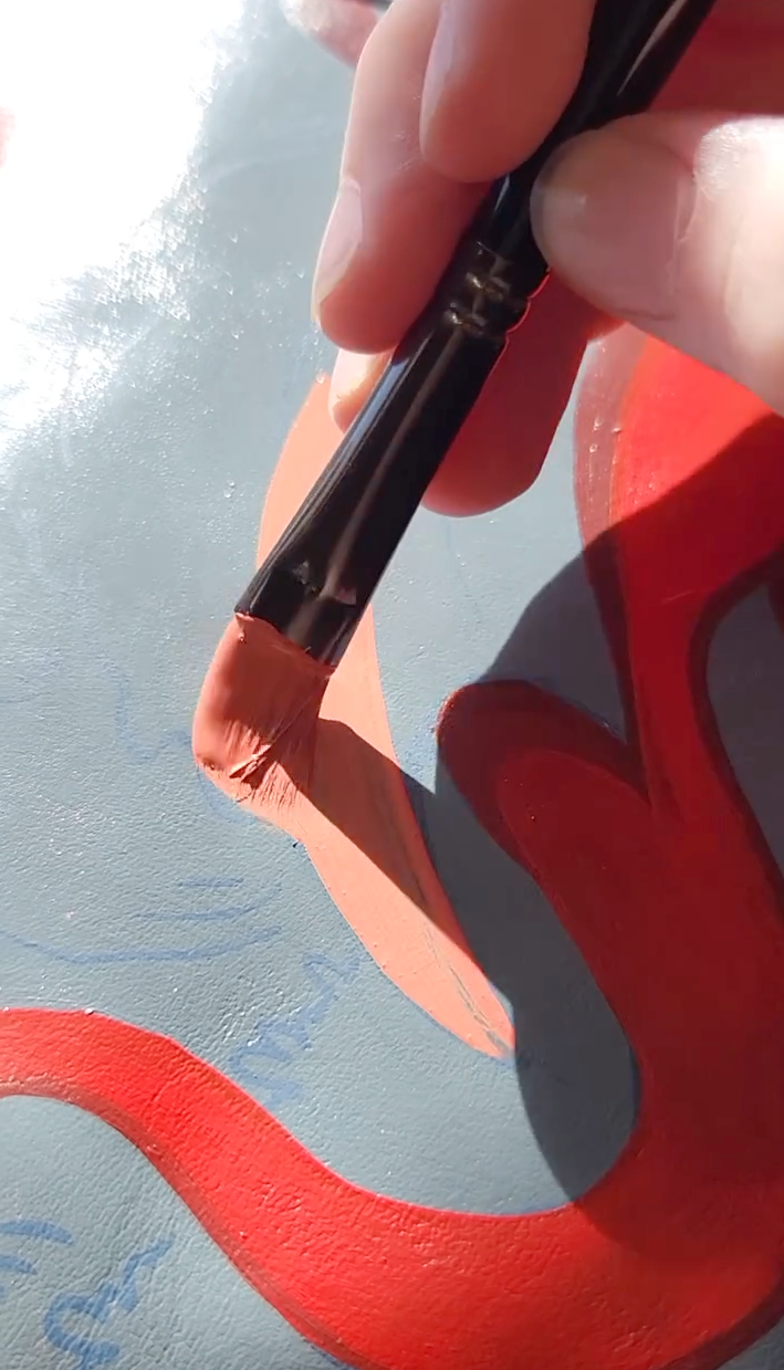 Applying red Angelus Leather Paint to a custom bag design