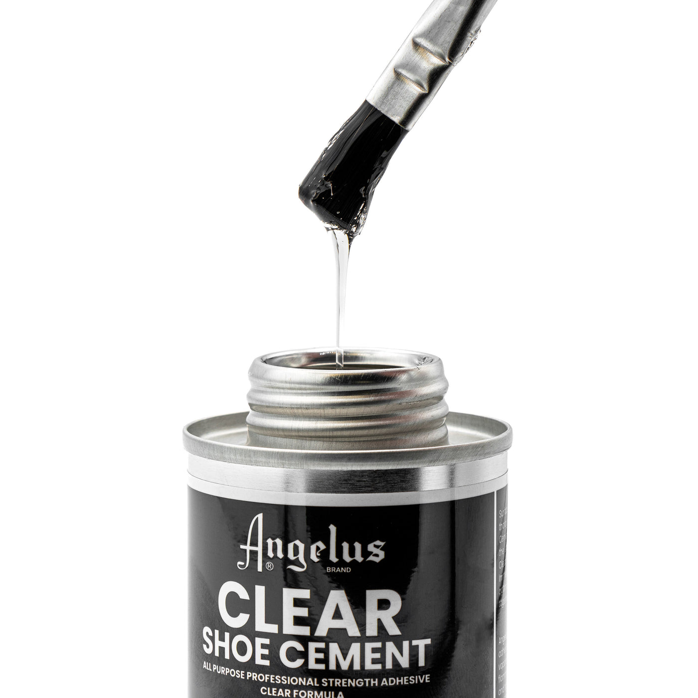 A brush coated with Angelus Direct’s Angelus Clear Shoe Cement is lifted from an open tin. The thick, stringy adhesive is ideal for re-gluing shoe soles or as an all-purpose glue.