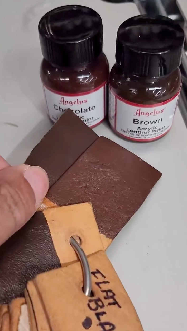 Angelus Acrylic Leather Paint bottles and professional sneaker customization brushes on a workbench