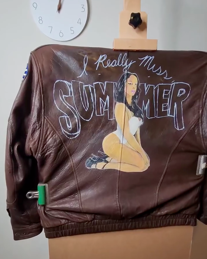 Sketching a custom typography design on leather using a silver marking pen and level